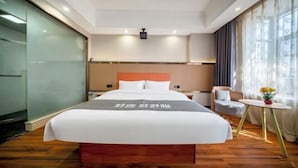 A hotel room with a bed, bedside tables, a chair, a small table with flowers, and a window with curtains. - Lexiang. Smart Audio-Visual Boutique Stay (Changle International Airport) (Fuzhou)