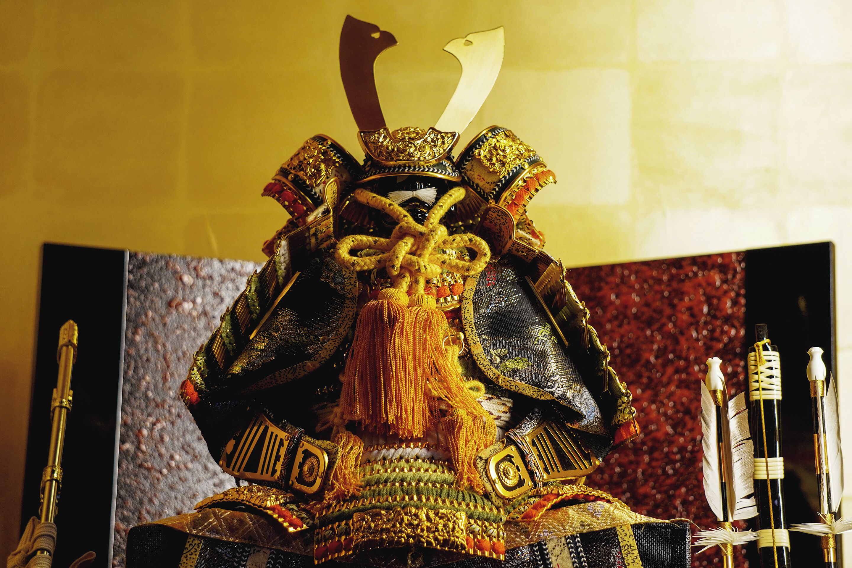 A traditional warrior costume with elaborate headgear and decorations.