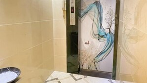 An elevator with a digital display, beige walls, and a decorative mural. - Kate Hotel (Guangzhou Dadao Yangxu Metro Station) (Guangzhou)