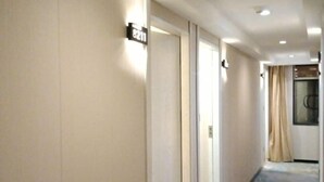 A hotel corridor with a sign indicating room number 8211. - Kate Hotel (Guangzhou Dadao Yangxu Metro Station) (Guangzhou)