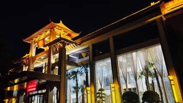 A building with a traditional architectural style, featuring a prominent entrance with a roof and columns.
