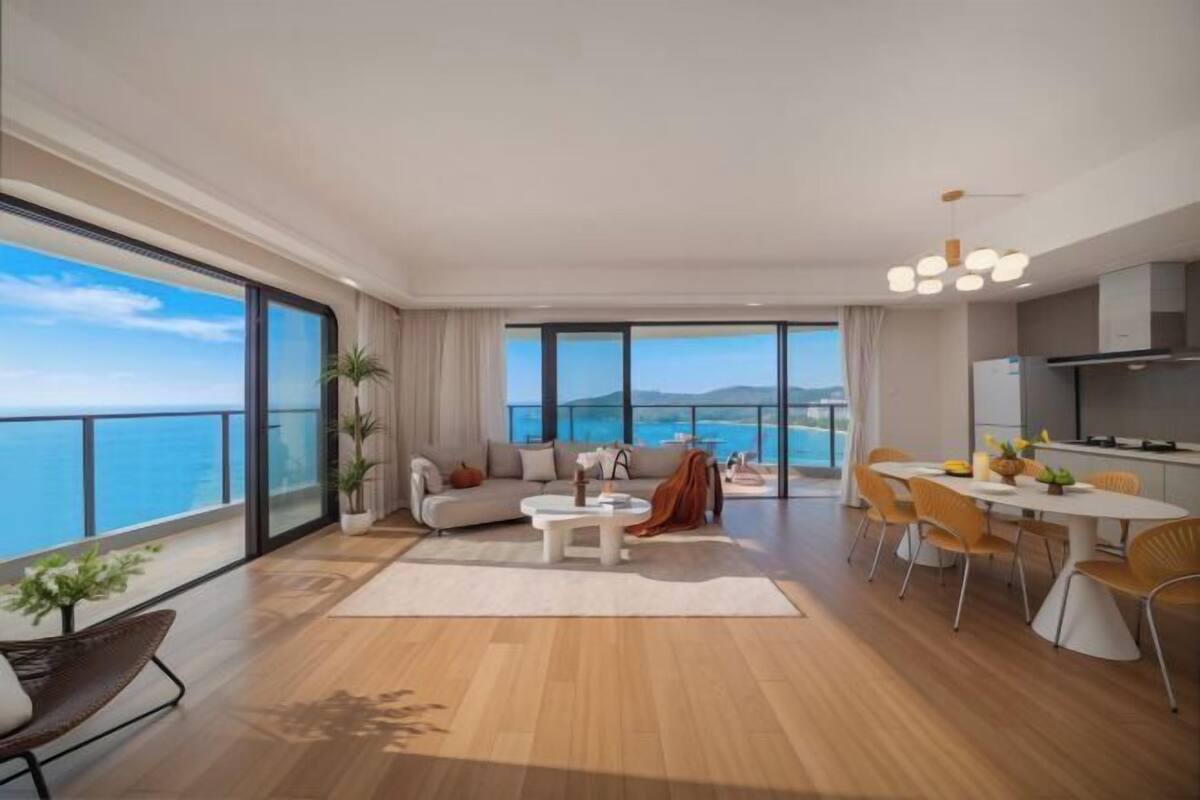 Una sala moderna con un gran ventanal, un comedor y una cocina.