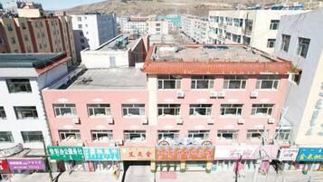 A multi-story building with a flat roof and multiple windows.
