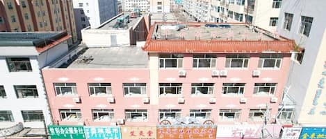 Um edifício com vários andares, teto plano e diversas janelas.