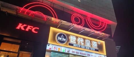 Un restaurante KFC con un letrero de neón y fachada visible.