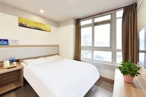 A hotel room with a bed, bedside table, a potted plant, a window with curtains, and a painting on the wall. - Homeinn Pebble Hotel (Beijing Tongren Hospital Chongwenmen Subway Station) (Beijing)