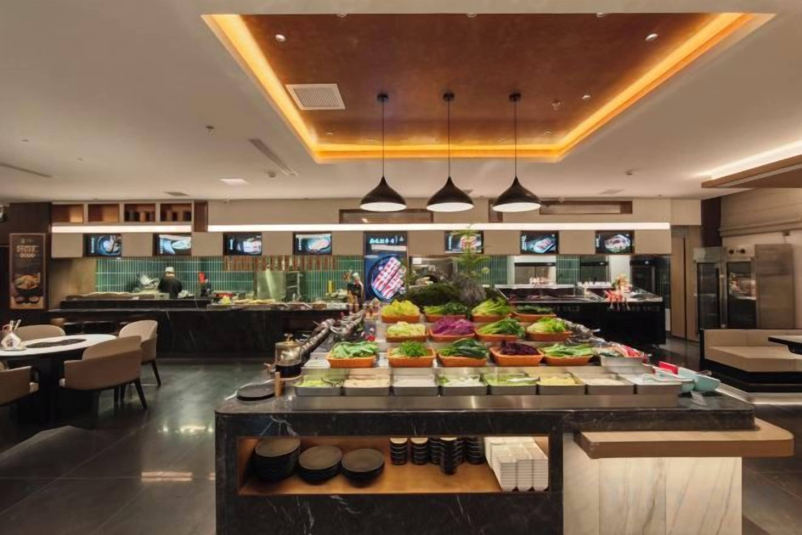 A buffet area with a variety of food options, a bar, and seating arrangements.