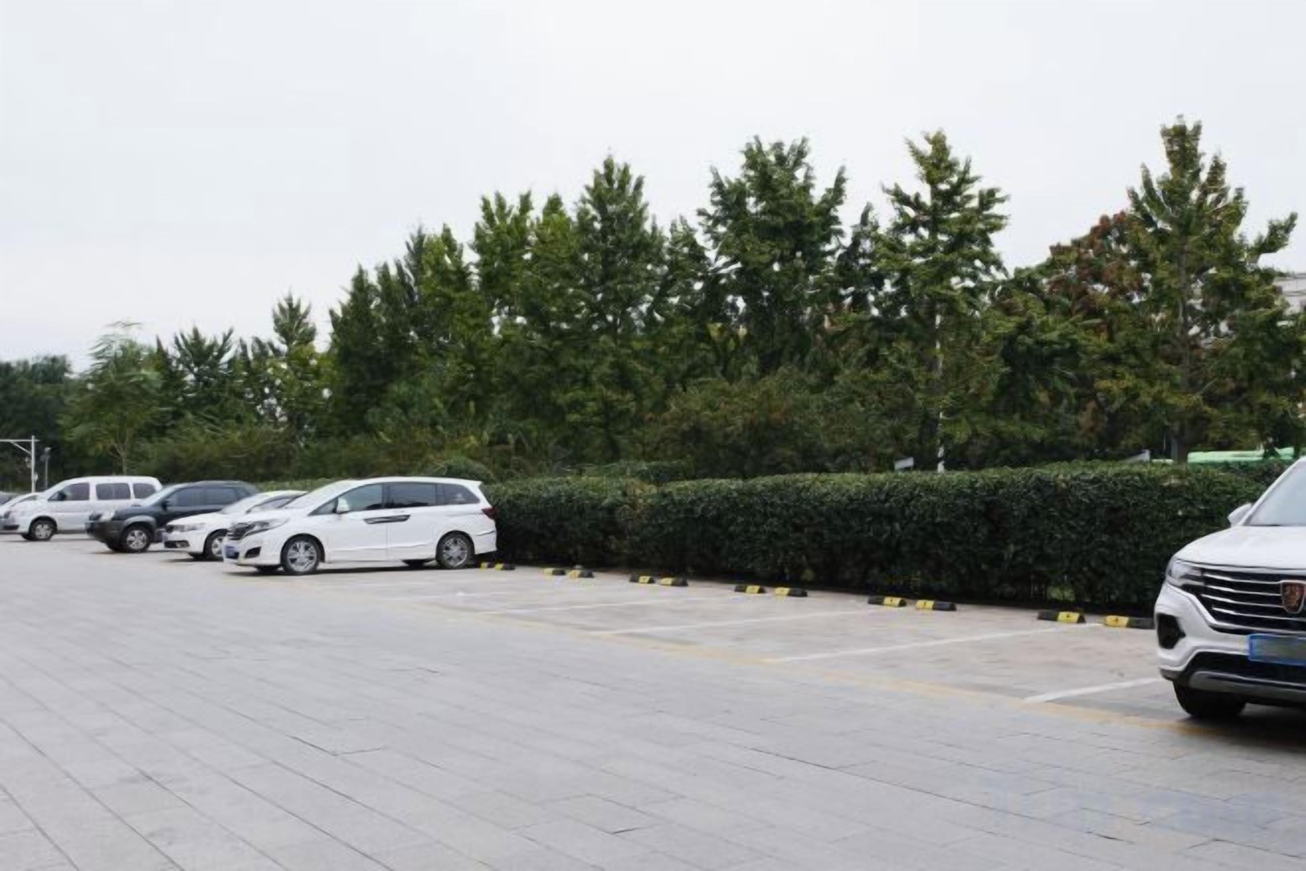 A parking lot with several cars parked.