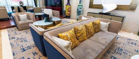 A modern lounge area with sofas, a coffee table, and decorative vases.