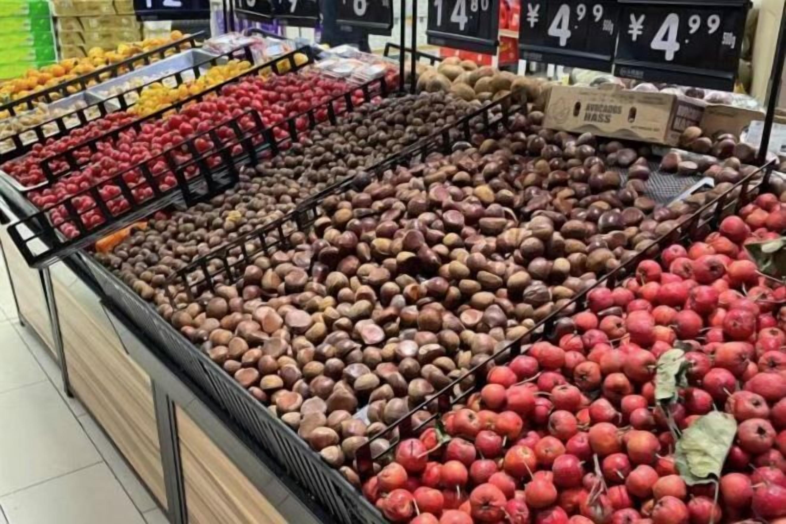 A produce display with various fruits and vegetables in a grocery store.