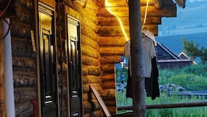 A log cabin with a wooden door and a coat hanging on a line. - Hemu Free Tribe Villa (Burqin)