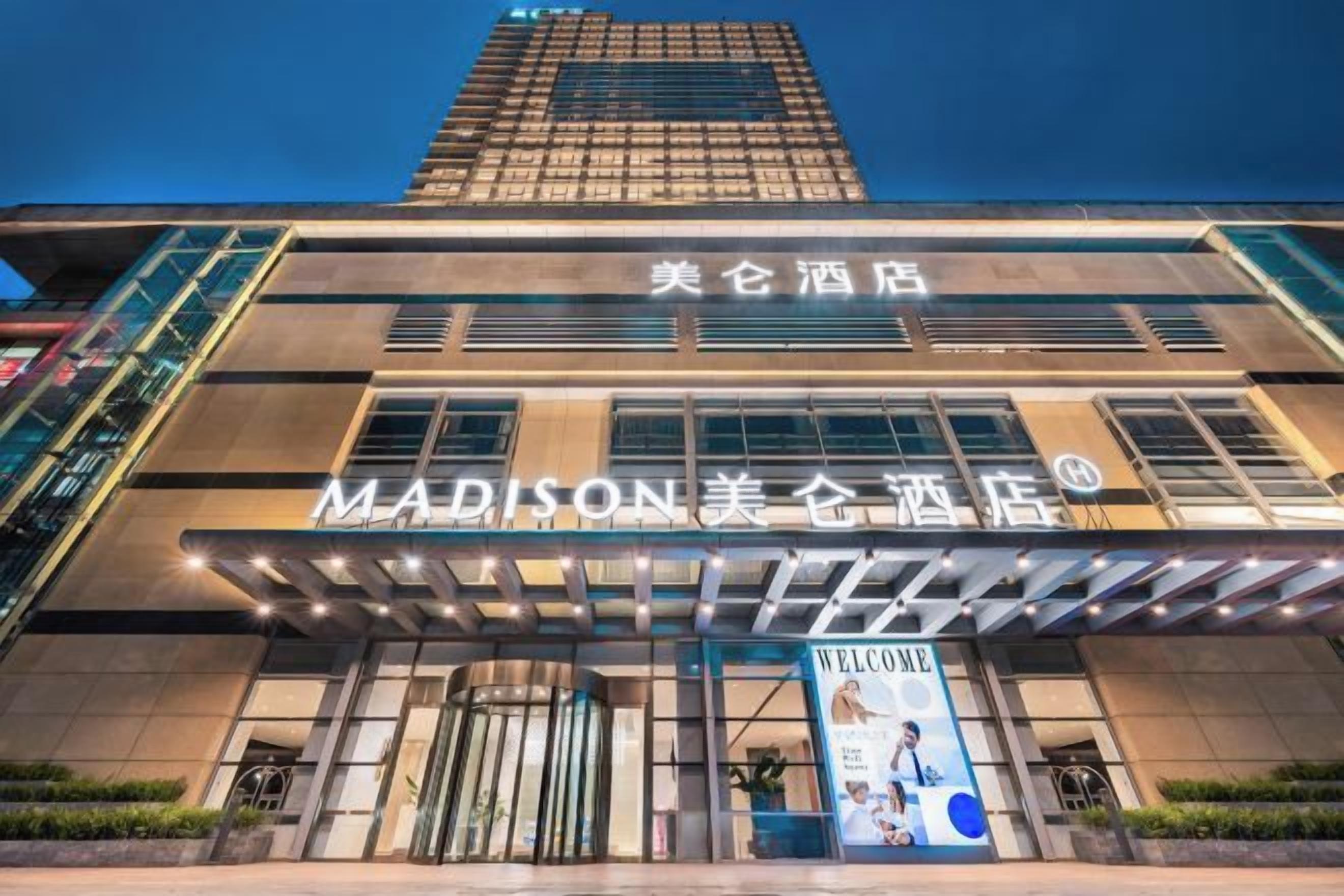 A hotel with a modern facade, a prominent entrance, and signage indicating it is the Madison Hotel.