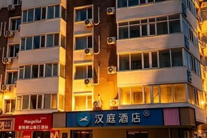 A hotel with multiple floors, air conditioning units, and a sign for '汉庭酒店.' - HanTing Hotel (Tianjin Railway Station Italian Style Street) (Tianjin)