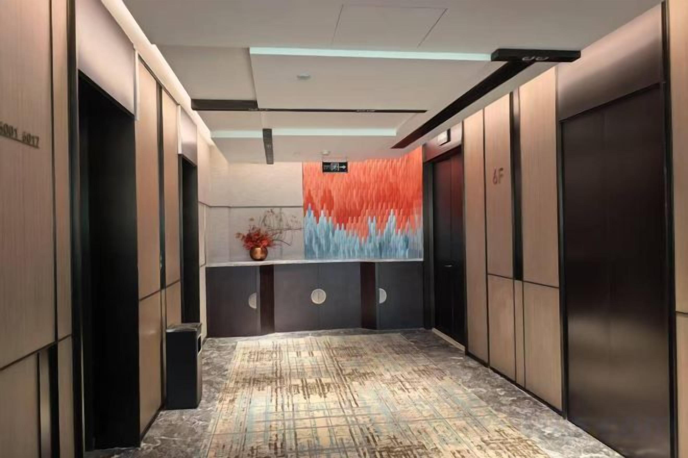 A modern elevator with a digital display and a patterned floor.