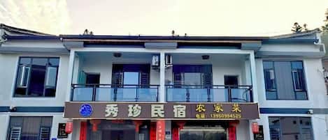 A two-story building with a signboard indicating a business establishment.
