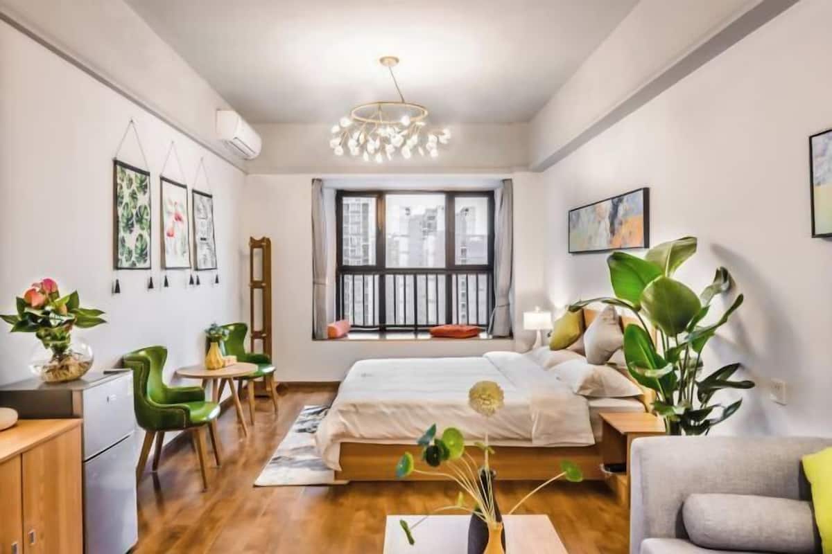 Un dormitorio moderno con cama, escritorio, silla y mesa de comedor.