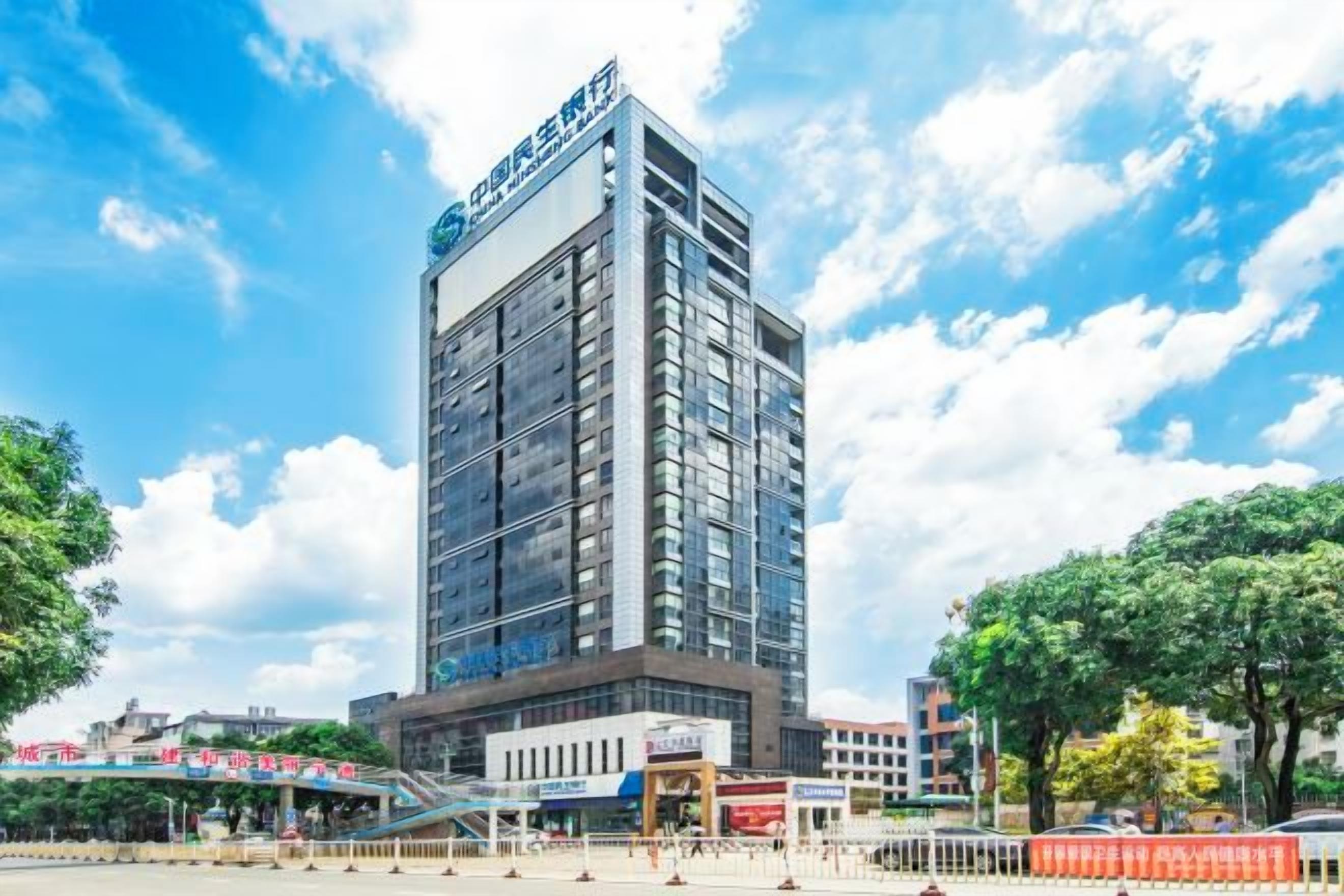 A modern hotel building with a prominent sign, multiple floors, and a flat roof.