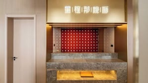 A reception area with a marble staircase, a red patterned wall, and a neon sign. - Starway Hotel (Liaocheng Zhenxing West Road) (Liaocheng)