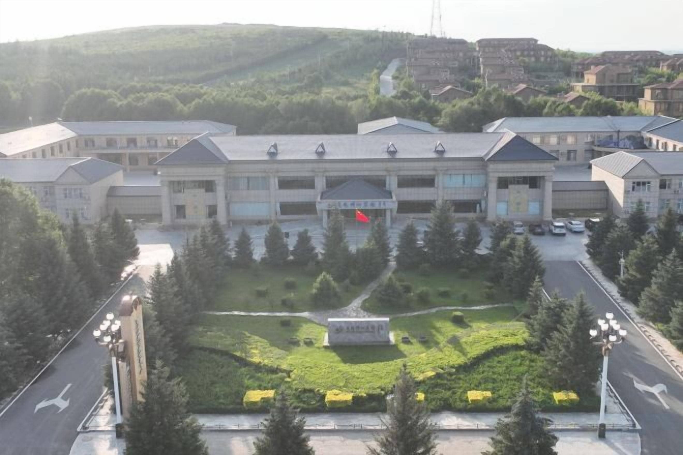 A large building with a symmetrical facade, multiple windows, and a central entrance.