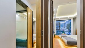 A modern hotel room with a large bed, a view of the city, and a wooden floor. - Dali Yunpingrui Boutique Homestay (Dali City)