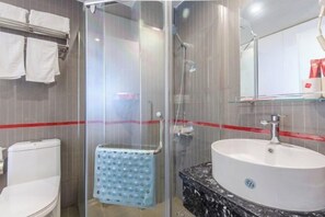 A modern bathroom with a glass-enclosed shower, a white sink with a marble countertop, and a towel rack with white towels. - Shankee Hotel (Anqing Qijie Railway Station) (Anqing)