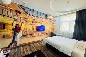 A hotel room with a large bed, a television, and a view of the hotel's atrium. - Hebi Diamond Fashion Hotel (Changfeng Road Dwang Square Branch) (Hebi)