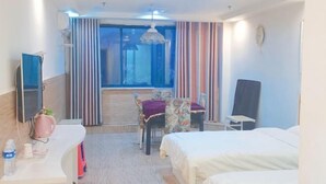 A hotel room with a bed, a desk with a computer, a chair, a window with curtains, and a television. - Hanting Hotel (Linchuan No. 2 Middle School) (Fuzhou)