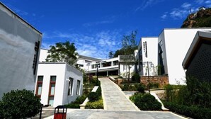 A modern building with a central staircase leading to a flat roof.