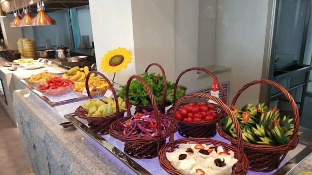A buffet with various fruits and vegetables arranged in baskets.