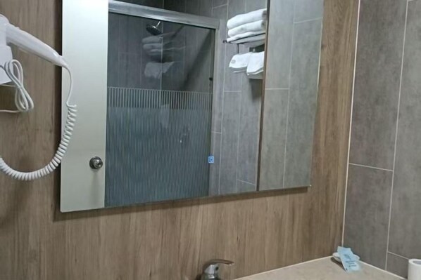 A bathroom with a hairdryer, a mirror, a towel rack, and a sink. - Vatican Art Hotel (Dongyun Road, Linwu County, Zhangzhou) (Linwu)