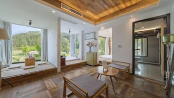 A modern interior with wooden flooring, a round table, and a bench.
