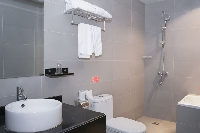 A bathroom with a sink, toilet, and shower.