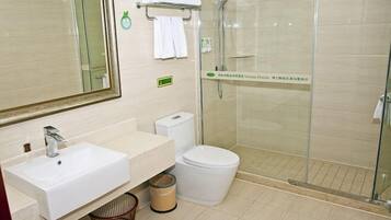 A bathroom with a sink, toilet, and glass-enclosed shower.