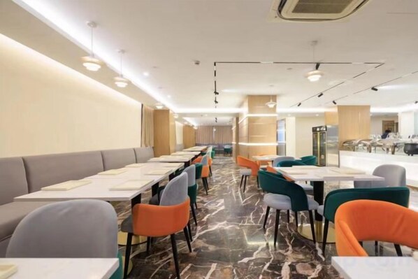 A restaurant with long tables and chairs, a marble floor, and a modern interior design.