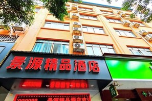 Un hotel con un letrero rojo llamativo y una pantalla digital.
