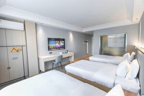 A hotel room with two beds, a desk, a TV, and a wardrobe. - 123 Hotel (Taizhou)