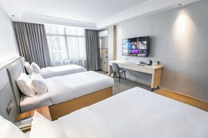 A hotel room with two beds, a desk, a TV, and a window with curtains. - 123 Hotel (Taizhou)