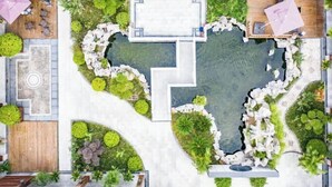 A top-down view of a hotel courtyard with a central pool, surrounded by seating areas and greenery. - Donglai Manor Hotel (Shanghai)