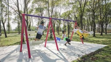 A playground with swings and a slide.