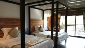 A room with two beds, a wooden headboard, a brick wall, and a large window. - Goose city story (Baise)