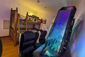 A bunk bed with a wooden headboard, a desk with a chair, and a computer tower with RGB lighting. - Amdo Express Hotel (Xining)