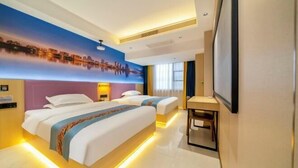A hotel room with two beds, a cityscape mural, a desk, and a TV. - Apollo Hotel (Zhangzhou Ancient City) (Zhangzhou)