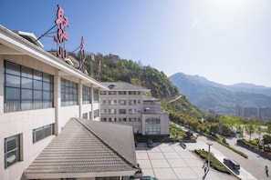 A building with multiple floors, large windows, and a flat roof. - Ju Xiu Hotel (Zhen'an)