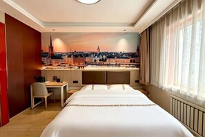 A hotel room with a bed, a desk, and a view of a cityscape. - Shengxian Hotel ＆Resorts (Dalian)