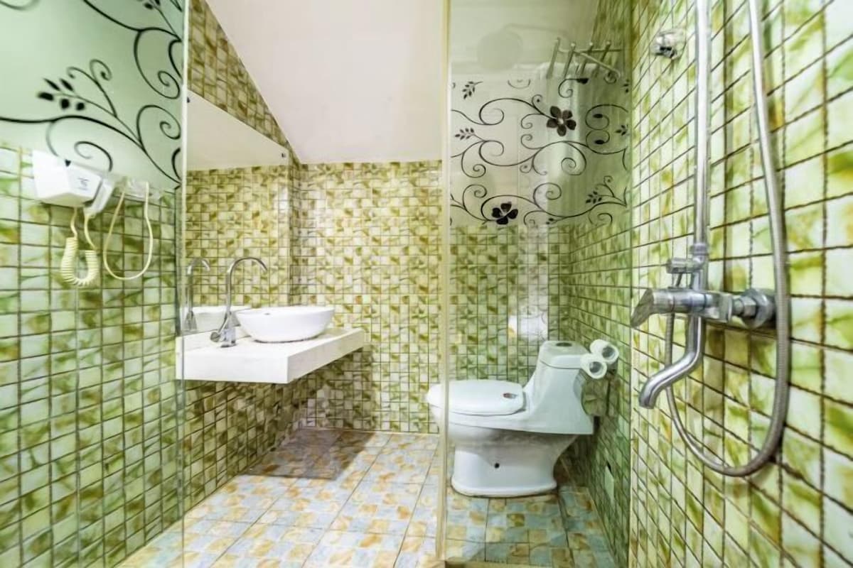 A bathroom with a toilet, sink, and shower.