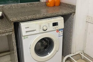 A front-loading washing machine with a control panel, a detergent dispenser, and a label indicating energy efficiency. - 8 Inn (Dongguan)
