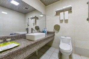 A bathroom with a white sink, mirror, and toilet. - 8 Inn (Dongguan)