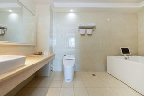 A modern bathroom with a large mirror, a sink, a toilet, and a bathtub. - Korla Apricot Business Hotel (Korla)