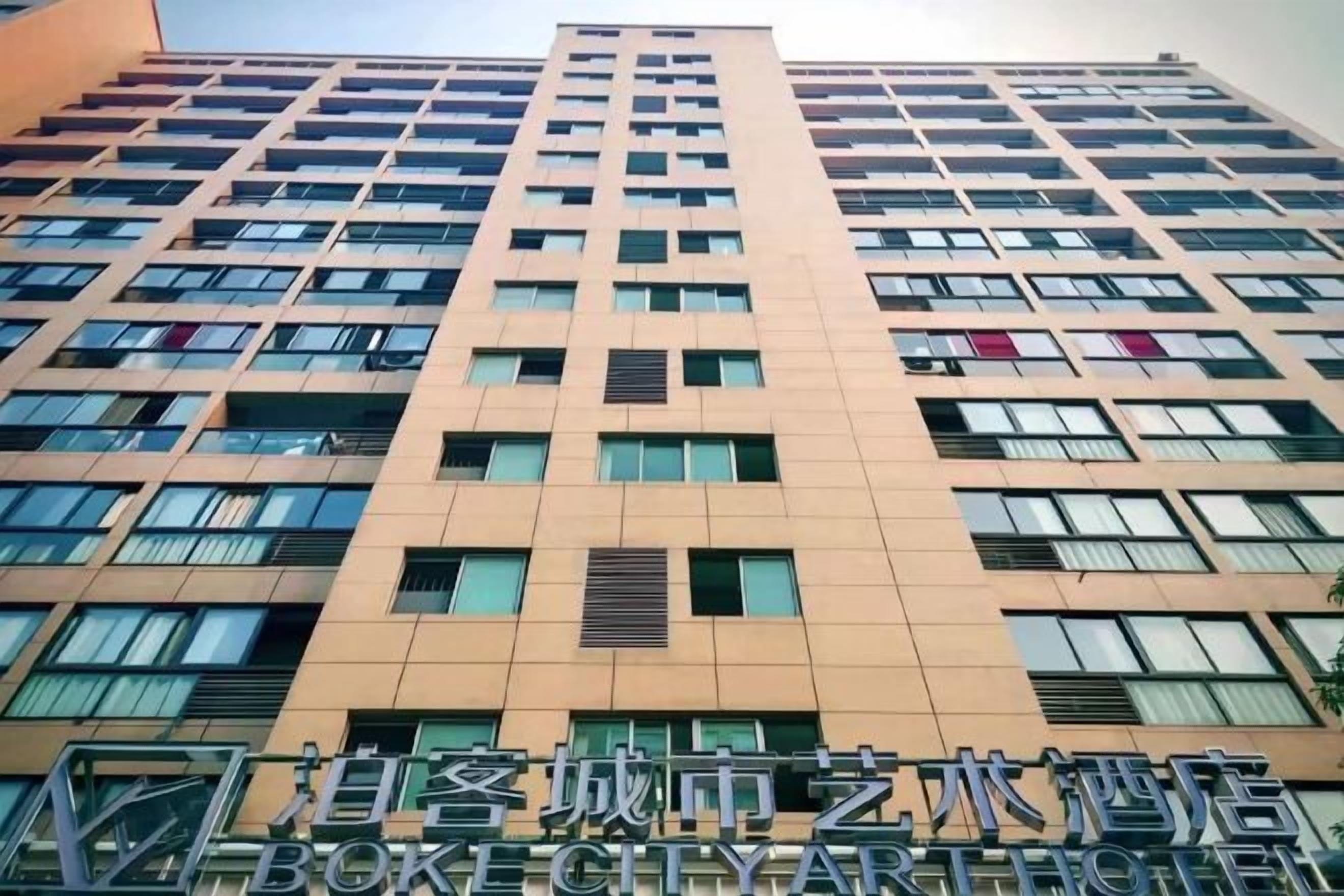 A multi-story building with a modern architectural design, featuring a series of windows and balconies.