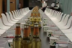 A conference table with chairs, bottles, and cups arranged for a meeting. - Midor Hotel (Honggutan Wanda Plaza) (Nanchang)